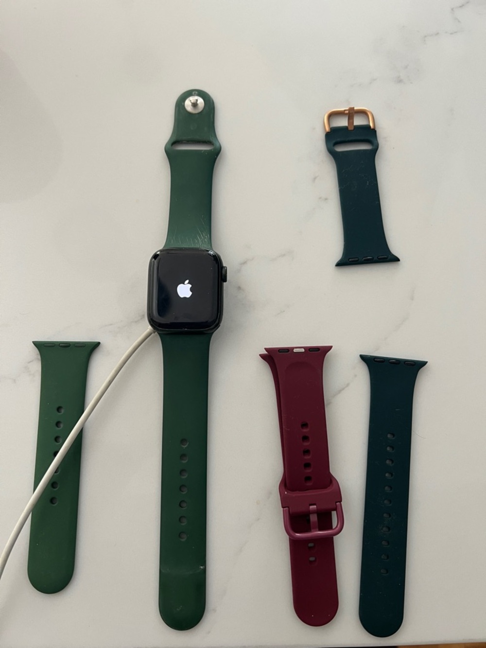 Apple Watch with Green, Teal, and Burgundy Silicone Bands series 7